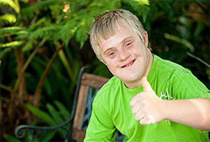 A man with down syndrome giving the thumbs up.